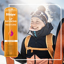 Woman skiing using Blistex Lip Infusion Restore